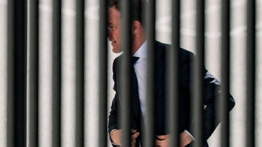 NATO Secretary General Mark Rutte walks into the White House, as seen through a fence, in Washington, D.C., U.S., April 8, 2026. REUTERS/Evan Vucci