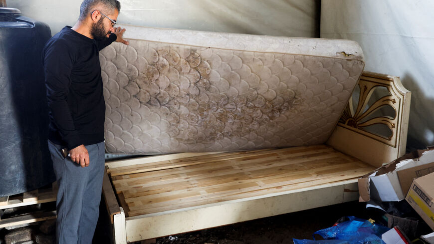 A Palestinian man looks at a wooden bed, amid shortages of materials, in Khan Younis, in the southern Gaza Strip, May 2, 2026. REUTERS/Haseeb Alwazeer
