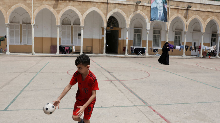 FILE PHOTO: A child plays in the yard of Hariri High School II, used as a temporary shelter for displaced people, in Beirut, Lebanon, May 2, 2026. REUTERS/ Raghed Waked/File Photo