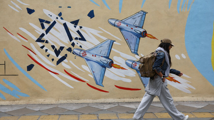 An Iranian woman walks next to an anti-Israeli mural on a street in Tehran, Iran, May 5, 2026. Majid Asgaripour/WANA (West Asia News Agency) via REUTERS