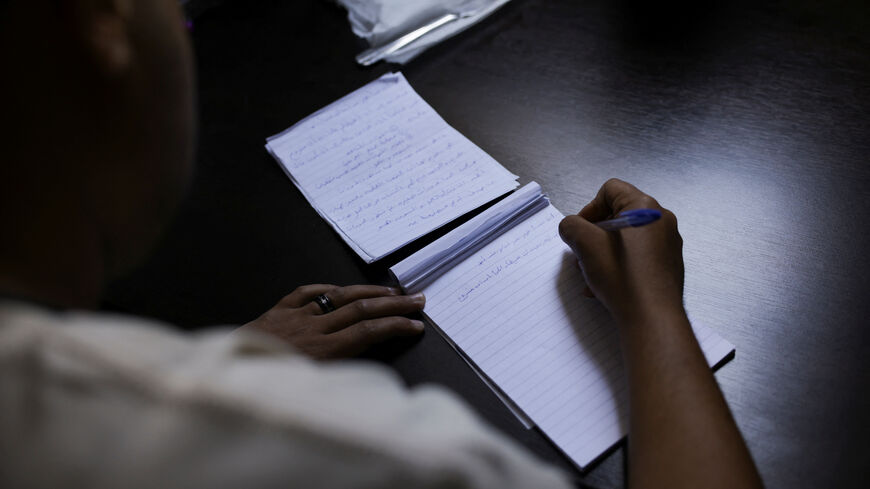 An Egyptian transgender man who escaped from Egypt due to persecution and asked to be identified by the name Mina for security reasons writes about his hopes in a temporary shelter for displaced people, in Beirut, Lebanon, May 4, 2026. REUTERS/Raghed Waked.
