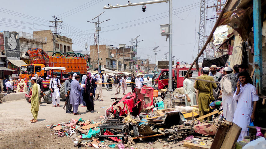 People and police officers in plain clothes gather after a blast at a market in Lakki Marwat, Khyber Pakhtunkhwa province, Pakistan, May 12, 2026. Picture taken with a mobile phone. REUTERS/Syed Basit