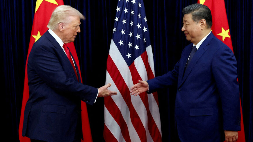 FILE PHOTO: U.S. President Donald Trump shakes hands with Chinese President Xi Jinping in Busan, South Korea, October 30, 2025. REUTERS/Evelyn Hockstein/File Photo