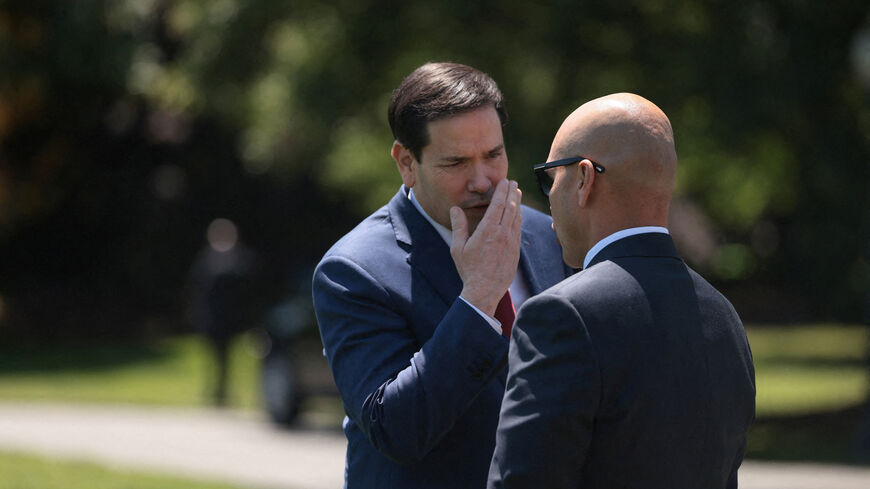 U.S. Secretary of State Marco Rubio talks with White House Director of Oval Office Operations Walt Nauta, ahead of U.S. President Donald Trump's departure from the White House for Joint Base Andrews en route to Beijing, China, in Washington, D.C., U.S., May 12, 2026. REUTERS/Evelyn Hockstein