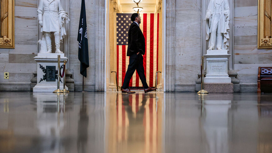 A person walks in front of an American flag in the Rotunda of the U.S. Capitol building in Washington, D.C., U.S., May 14, 2026. REUTERS/Kylie Cooper