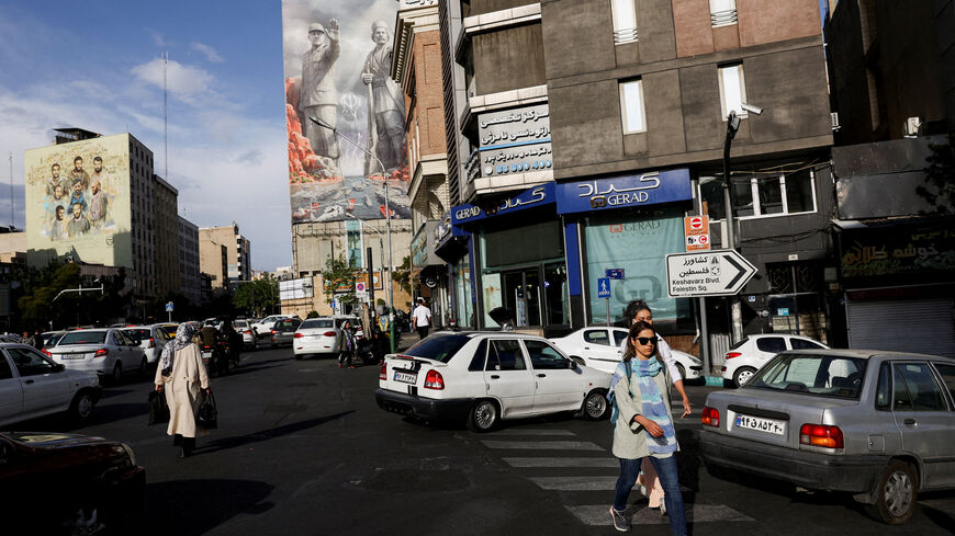 FILE PHOTO: People walk past a billboard about the Strait of Hormuz, in Tehran, Iran, May 17, 2026. Majid Asgaripour/WANA (West Asia News Agency) via REUTERS/File Photo