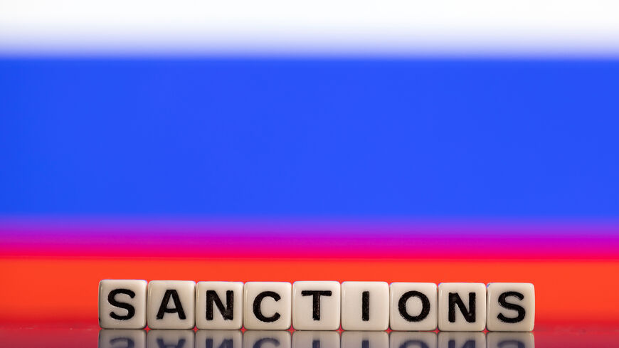 Plastic letters arranged to read "Sanctions" are placed in front of Russian flag colors in this illustration taken February 25, 2022. REUTERS/Dado Ruvic/Illustration