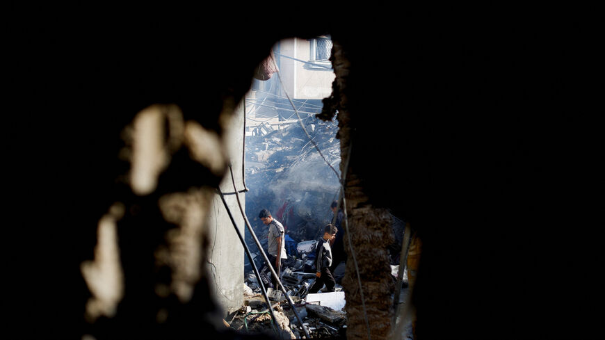Palestinians inspect the site of an Israeli strike on a house that was pre-warned by the Israeli military to evacuate before the strike was carried out late on Saturday, in Deir al-Balah, in the central Gaza Strip, May 24, 2026. REUTERS/Mahmoud Issa