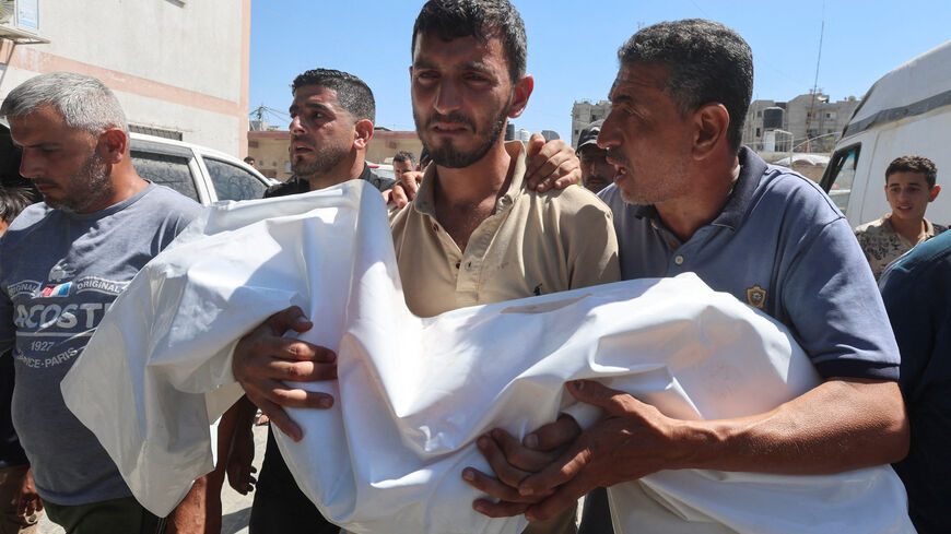 A mourner carries the body of six-year-old Palestinian girl Mennatallah Abu Libda, who was killed in an Israeli strike on a tent encampment for displaced families, according to medics, in Khan Younis in the southern Gaza Strip May 25, 2026. REUTERS/Ramadan Abed