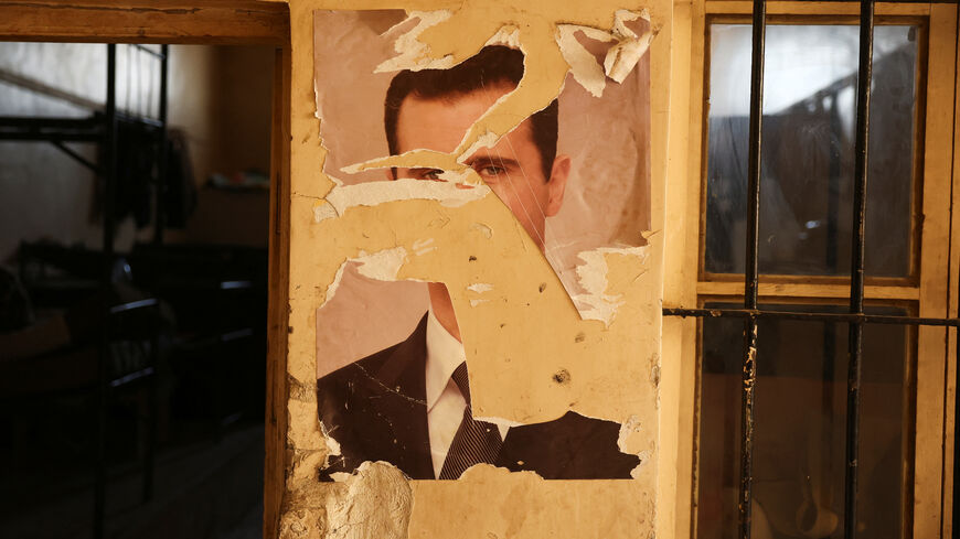 A damaged portrait of former Syrian President Bashar al-Assad at a military base in Damascus, Syria, December 15, 2024. REUTERS/Amr Alfiky
