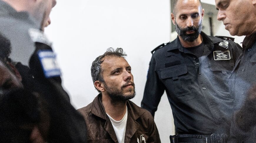 Brazil's activist Thiago Avila is escorted into court in the Israeli coastal city of Ashkelon
