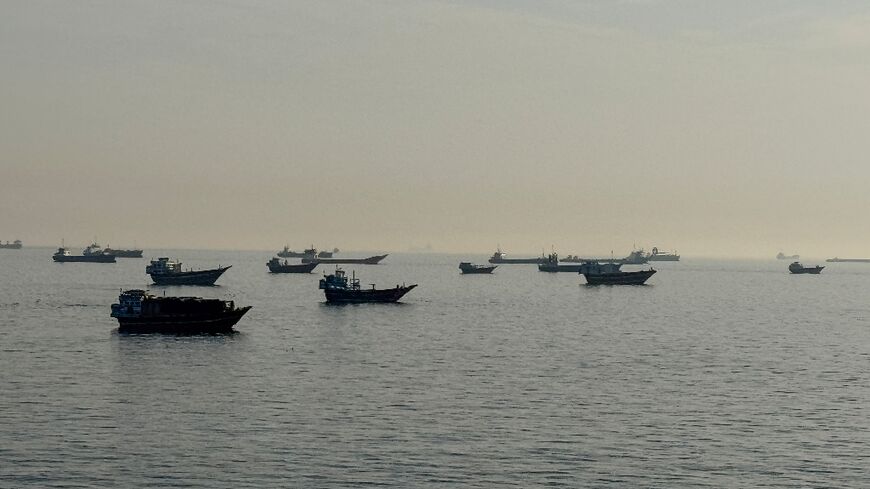 Vessels are seen anchored in the Strait of Hormuz, off the port city of Khasab on Oman's northern Musandam Peninsula on May 17, 2026