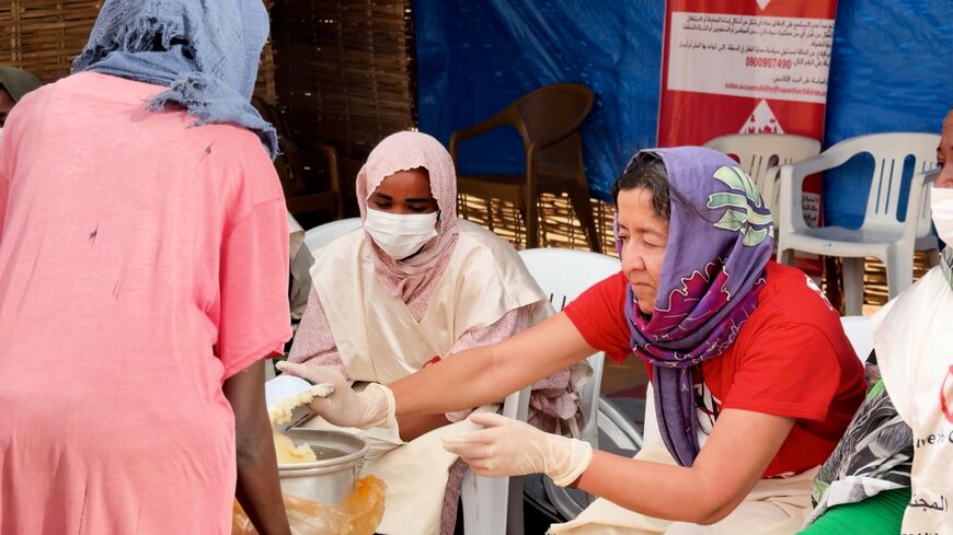 Janti Soeripto helps at a community kitchen serving hot meals to displaced families arriving from El-Fasher.