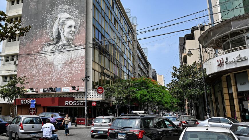 Vehicles move past a giant mural on the side of a building showing an image of the late Lebanese actress and singer Sabah (1927-2014) along Beirut's Hamra street on June 20, 2024. 