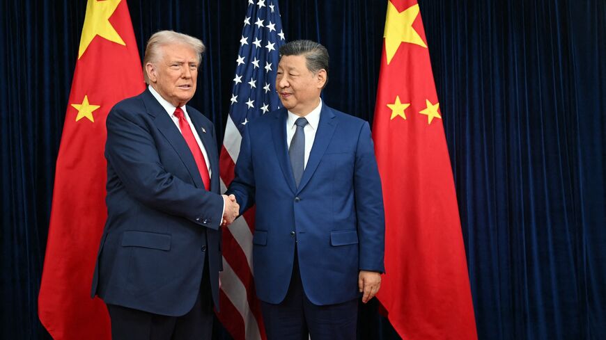 US President Donald Trump and Chinese President Xi Jinping shake hands as they arrive for talks at the Gimhae Air Base in Busan, South Korea, on Oct. 30, 2025.