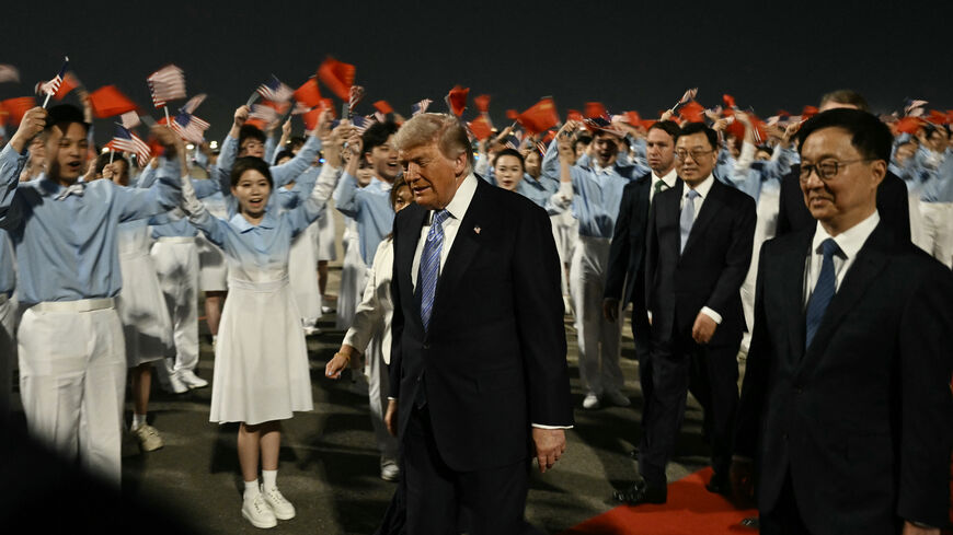TOPSHOT - US President Donald Trump (C) is escorted by China's Vice President Han Zheng (R) upon his arrival at Beijing Capital Airport in Beijing on May 13, 2026. (Photo by Brendan SMIALOWSKI / AFP via Getty Images)