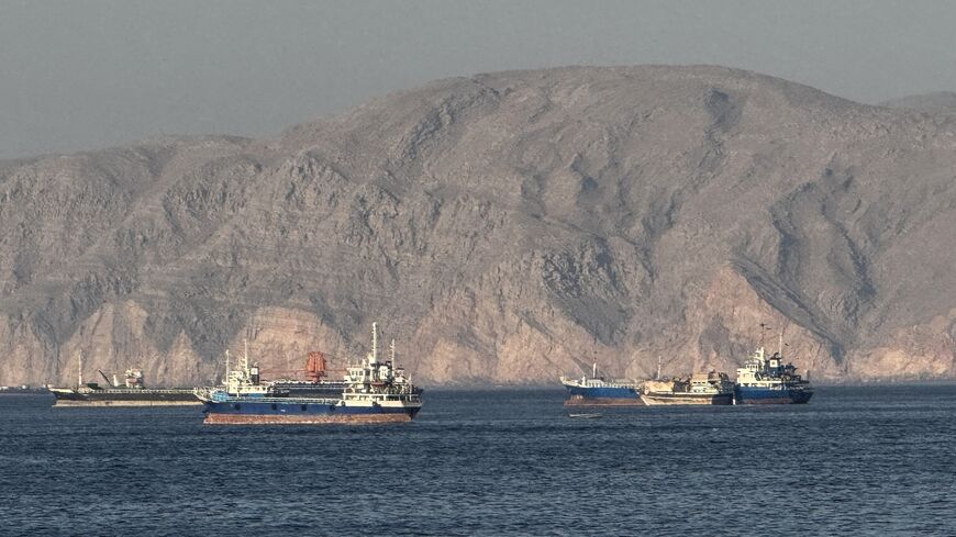Vessels are seen anchored in the Strait of Hormuz, off the port city of Khasab on Oman's northern Musandam Peninsula on May 17, 2026. 