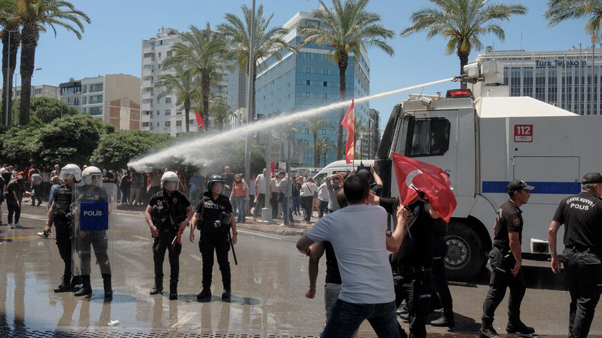 Turkish riot police use water cannon to disperse protesters during a rally called by ousted opposition leader Ozgur Ozel, days after a court dismissed him from office, in Izmir on May 26, 2026. 