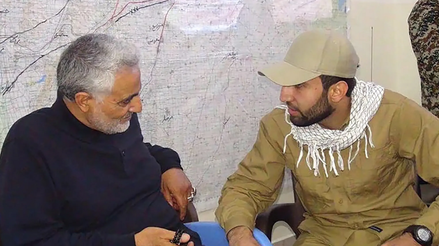 An undated image released by the Justice Department shows Mohammad Baqer Saad Dawood al-Saadi (R) speaking with Iranian Quds Force Commander Qasem Soleimani, who was killed in a US strike in 2020.