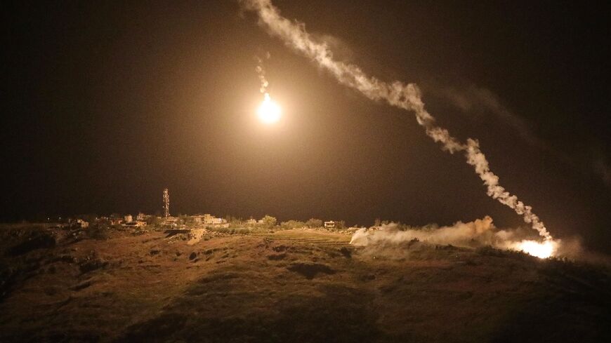 A photograph taken from the southern area of Marjayoun shows flares fired by the Israeli military descending over the village of Arnoun late on May 13, 2026