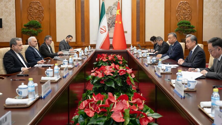  In this photo released by Xinhua News Agency, Chinese Foreign Minister Wang Yi, second right, talks to his Iranian Counterpart Abbas Araghchi, left, during the bilateral meeting in Beijing, Wednesday, May 6, 2026.