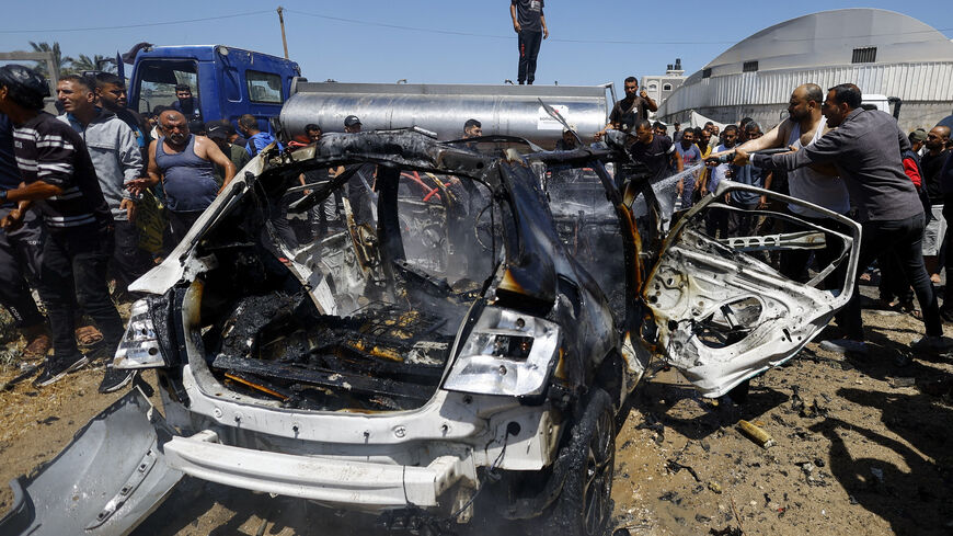 Palestinians gather at the site of an Israeli strike on a vehicle, in Deir al-Balah, in the central Gaza Strip June 2, 2026. REUTERS/Mahmoud Issa