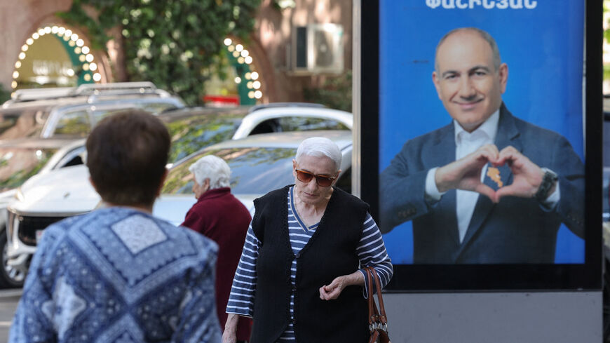 People walk past campaign banners with portraits of Prime Minister Nikol Pashinyan of the Civil Contract party, ahead of the June 7 parliamentary election, in Yerevan, Armenia June 3, 2026. Hayk Baghdasaryan/Photolure via REUTERS ATTENTION EDITORS - THIS IMAGE HAS BEEN SUPPLIED BY A THIRD PARTY.