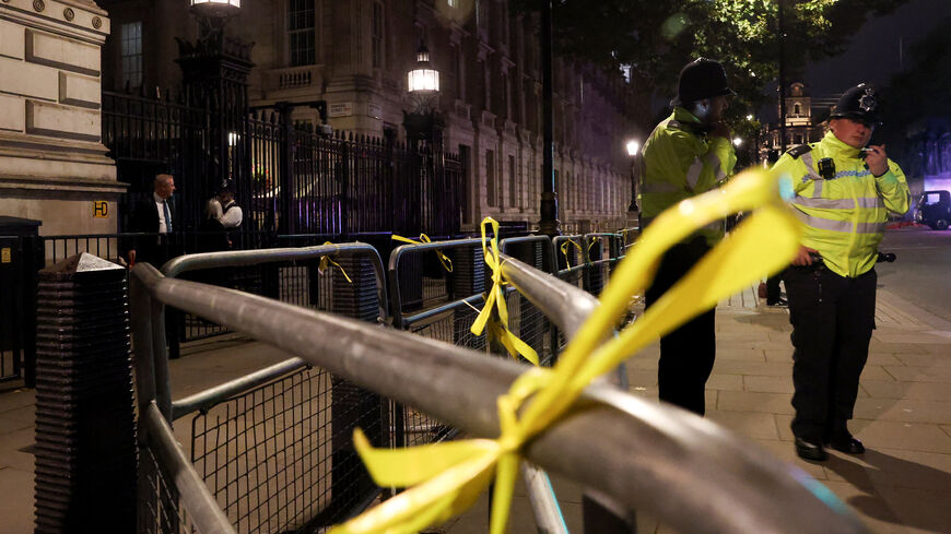 FILE PHOTO: Yellow ribbons hang on security railings outside Downing Street, placed by supporters of Campaign Against Antisemitism to remember the hostages still being held by Hamas as demonstrators gather outside Downing Street to demand stronger government action against antisemitism, one week after the deadly Manchester synagogue attack, in London, Britain, October 9, 2025. REUTERS/Toby Melville/File Photo