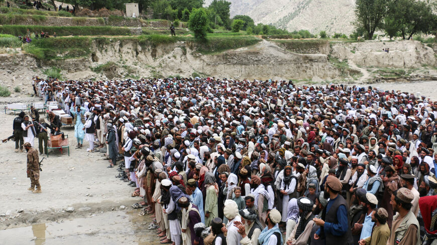 People offer funeral prayers as they gather near coffins containing the bodies of victims who died in what the Taliban said was a Pakistani airstrike in Mani village, Spera District, Khost Province, Afghanistan, June 10, 2026. REUTERS/Stringer