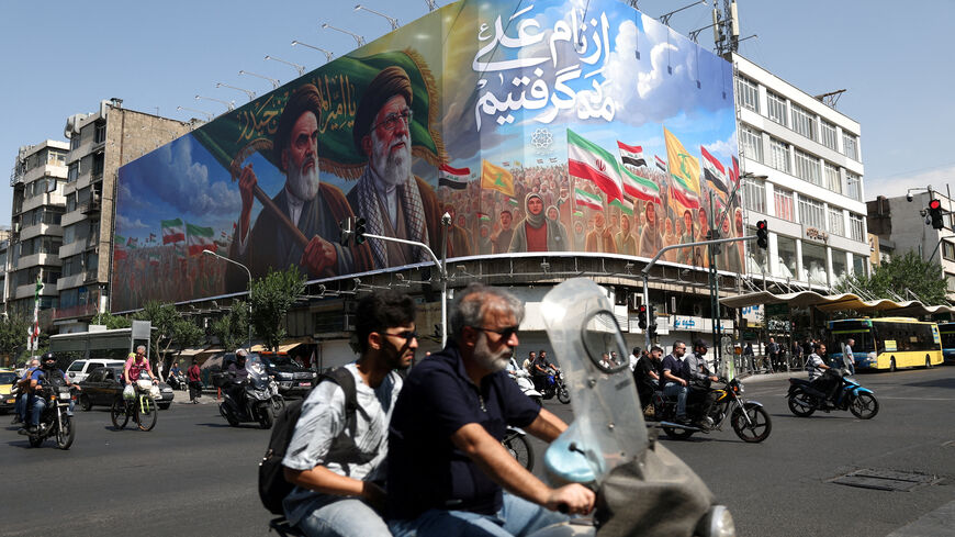 People ride past a billboard depicting the late leader of the Islamic Revolution, Ayatollah Ruhollah Khomeini, and the late Iran's Supreme Leader Ayatollah Ali Khamenei, on a street in Tehran, Iran, June 10, 2026. Majid Asgaripour/WANA (West Asia News Agency) via REUTERS