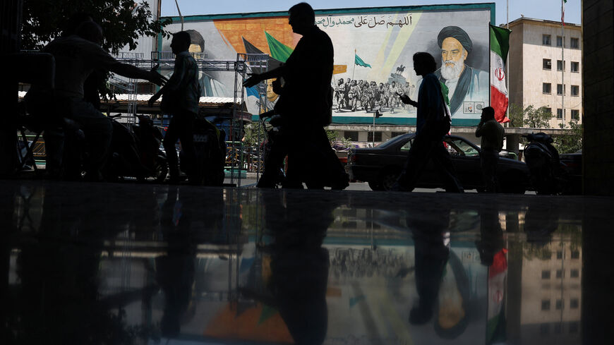 People walk near a mural depicting the late leader of the Islamic Revolution, Ayatollah Ruhollah Khomeini, and Iran's late Supreme Leader Ayatollah Ali Khamenei, on a street in Tehran, Iran, June 14, 2026. Majid Asgaripour/WANA (West Asia News Agency) via REUTERS