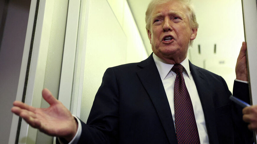 FILE PHOTO: U.S. President Donald Trump speaks to reporters aboard Air Force One on a flight back to Washington March 15, 2026. REUTERS/Kevin Lamarque/File Photo
