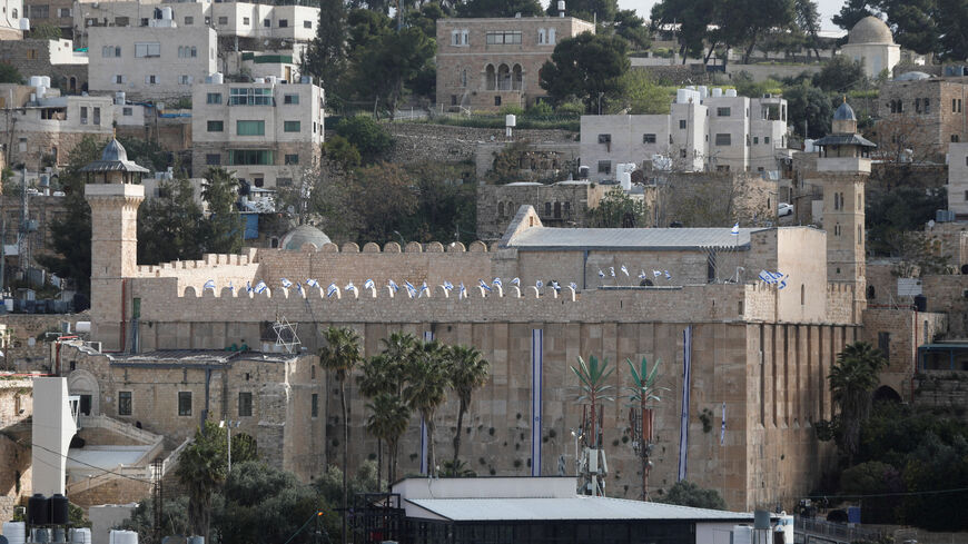 FILE PHOTO: Israeli flags flutter on the Ibrahimi mosque, also known as the Cave of the Patriarchs, in Hebron, in the Israeli-occupied West Bank April 21, 2026. REUTERS/Yosri Aljamal/File Photo