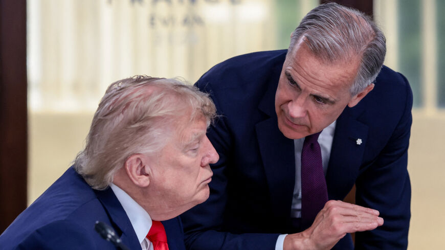 U.S. President Donald Trump speaks with Canadian Prime Minister Mark Carney at a working lunch with leaders of G7 and the Middle East, in Evian-les-Bains, France, June 16, 2026. REUTERS/Evelyn Hockstein/Pool