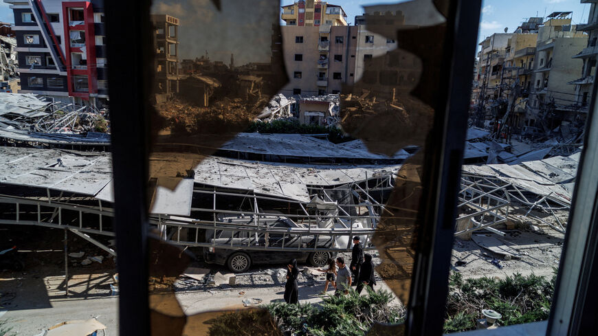 People walk past rubble at the site of an Israeli strike following a deal between the U.S. and Iran in Tyre, southern Lebanon, June 16, 2026. REUTERS/Zohra Bensemra