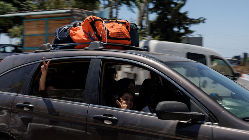 A family drives with belongings loaded on top of their car, fleeing southern Lebanon again, heading North after returning following the U.S.-Iran deal, as overnight fighting between Israeli forces and Hezbollah resumes, on the outskirts of Tyre, in southern Lebanon June 19, 2026.REUTERS/Zohra Bensemra