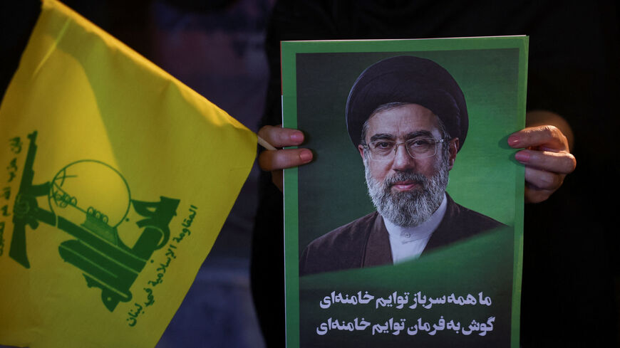 A woman holds an image of Iran's Supreme Leader, Mojtaba Khamenei, and a Hezbollah flag during a rally in Tehran, Iran, June 1, 2026. Majid Asgaripour/WANA (West Asia News Agency) via REUTERS