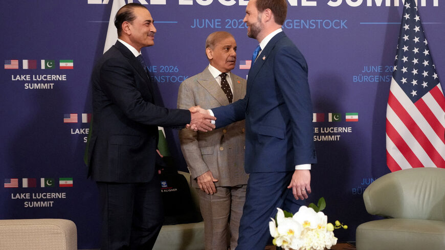 FILE PHOTO: U.S. Vice President JD Vance shakes hands with Pakistan's Chief of Army Staff Field Marshal Asim Munir, next to Pakistan's Prime Minister Shehbaz Sharif, as they meet for high-level talks aimed at advancing a deal to end the Middle East conflict, at the Buergenstock Resort Lake Lucerne, near Stansstad, Switzerland, June 21, 2026. REUTERS/Nathan Howard/Pool/File Photo