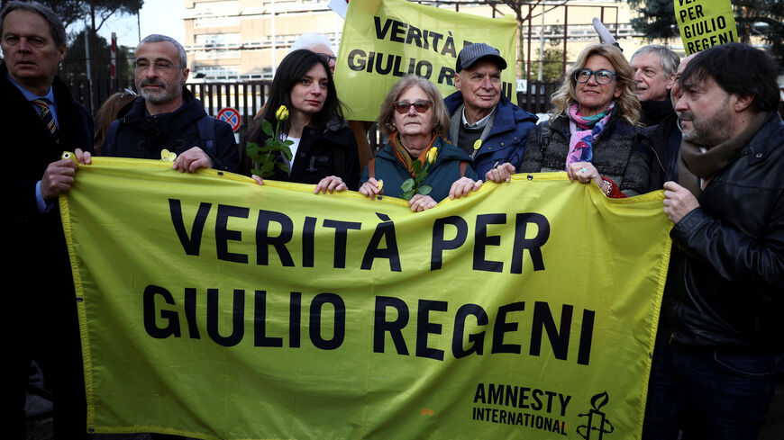 FILE PHOTO: Paola and Claudio Regeni, parents of Italian student Giulio Regeni, hold a banner outside the courthouse on the day of the trial of four senior members of Egyptian security services over their suspected role in his disappearance and murder in Cairo in 2016, in Rome, Italy, February 20, 2024. The banner reads: "Truth for Giulio Regeni". REUTERS/Guglielmo Mangiapane/File Photo
