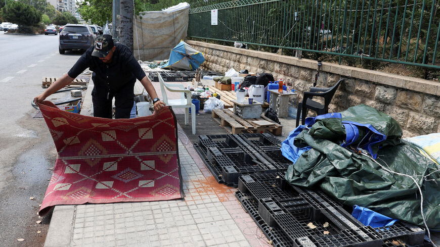 FILE PHOTO: Alaa Kobeissy packs his belongings on a sidewalk in Beirut, where he and his family have been living in a tent, as he prepares to return home following an interim deal between the U.S. and Iran, in Beirut, Lebanon, June 24, 2026. REUTERS/Mohamed Azakir/File Photo