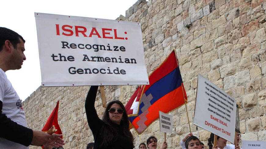 Members of the Jerusalem Armenian community hold placards as they march during commemorations for the 94th anniversary of mass killings of their kin under the Ottoman Empire, Jerusalem's Old City, April 24, 2009.