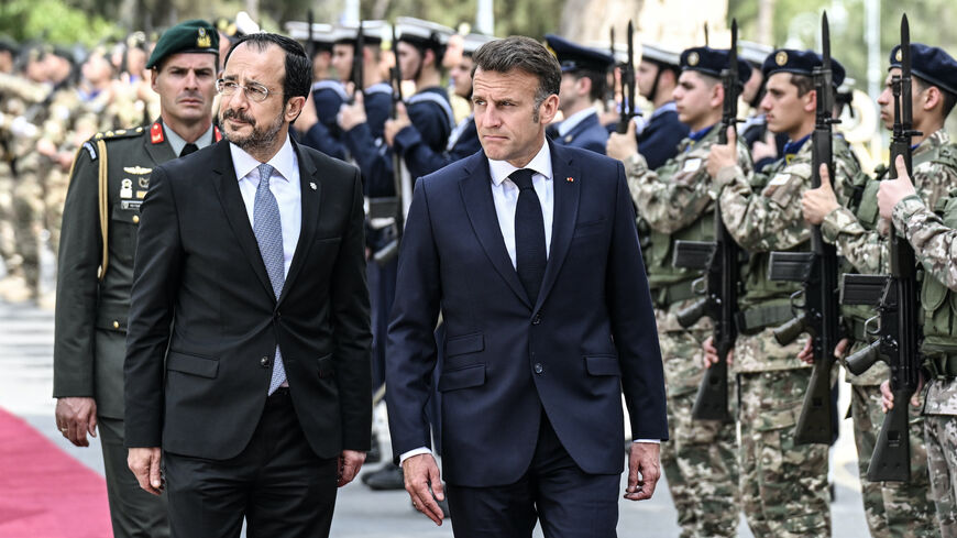 Cyprus' President Nikos Christodoulides (2nd L) and his French counterpart Emmanuel Macron (C) review the honor guard at the Presidential Palace in Nicosia on April 23, 2026, ahead of a meeting on the sidelines of a European summit. 