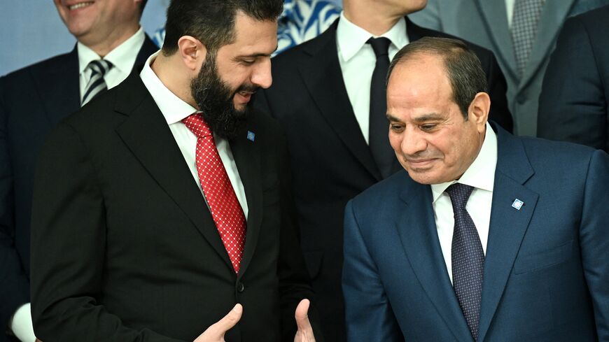 Syria's President Ahmed al-Sharaa (L) chats with Egypt's President Abdel Fattah al-Sisi as they arrive for a family photo after a working session of the European Council and regional partners as part of an informal meeting in Nicosia on April 24, 2026.