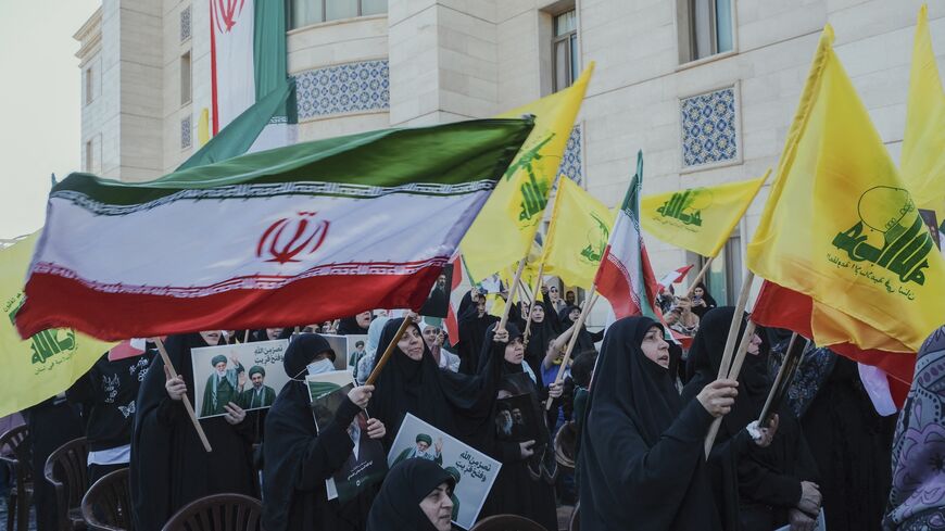 Veiled women in black Chadors wave Iran and Hezbollah flags during commemoration at the Iranian embassy in Beirut, Lebanon, on April 22, 2026.
