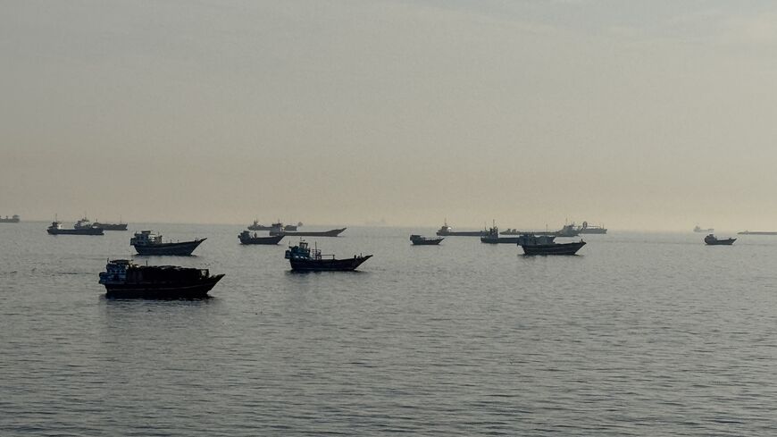 Vessels are seen anchored in the Strait of Hormuz, off the port city of Khasab on Oman's northern Musandam Peninsula, on May 17, 2026. 