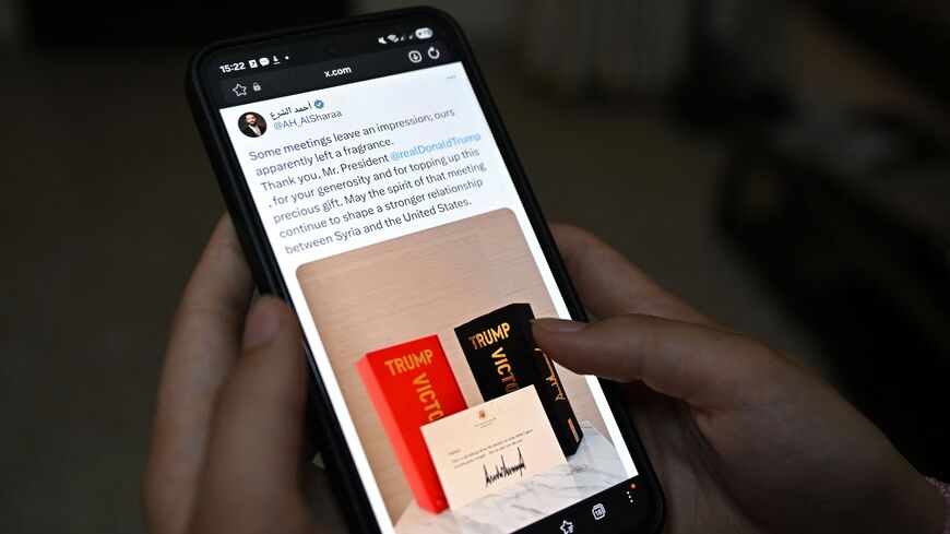 This photo illustration taken in Damascus on May 20, 2026, shows the X account of Syrian President Ahmed al-Sharaa on a smartphone displaying his tweet to President Donald Trump. 