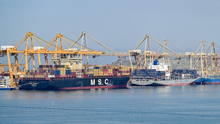 The Liberia-flagged container vessel MSC Tasman VI and the Singapore-flagged container vessel Wan Hai 353 are docked along a pier at the Khor Fakkan Container Terminal, the only natural deep-sea port in the region and one of the major container ports in Sharjah Emirate, along the Gulf of Oman on June 19, 2026. 