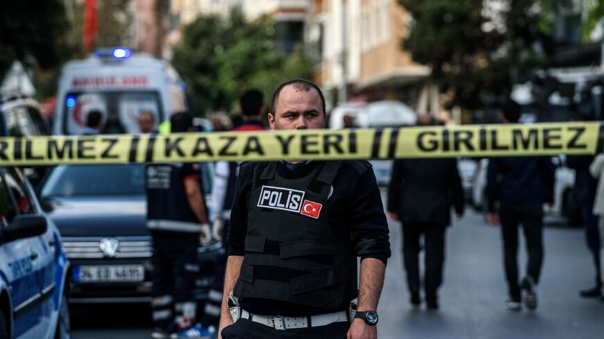 A Turkish police officers patrols at the scene of a motor-bike bomb explosion, next to a police station on Oct. 6, 2016, in Istanbul. 