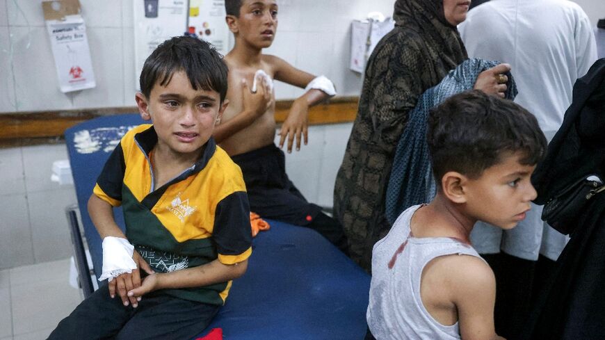 Palestinian children wounded by Israeli strikes wait for medical care in Gaza's Nasser Medical Complex