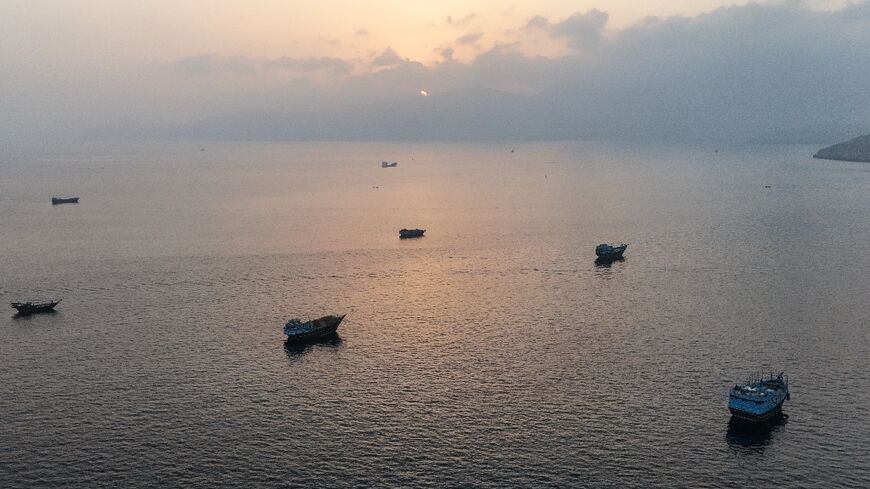 This aerial photograph shows boats anchored off Oman's northern Musandam Peninsula near the Strait of Hormuz on June 27, 2026